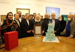 Painter Hossein Mahjubi (C), the organizers and guests pose for a photograph during the 92nd birthday celebration of the artist at the Sadabad Cultural and Historical Complex in Tehran on May 13, 2022