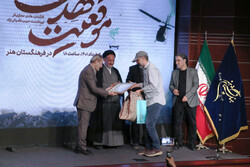 IAA director Bahman Namvar-Motlaq (L) awards director Hadi Hejazifar with the IAA Plaque of Glory for his film “The Situation of Mehdi” in Tehran on May 24, 2022.