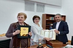 Georgian Iranologist Lili Žoržoliani (L) holds the Shahriar Medal after receiving the honor from Iranian cultural attaché Ahmad-Ali Mehri (3rd L) as Tea Shurgaia of the Iranian Studies Department is s