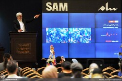 Auctioneer Hossein Pakdel takes a bid for the sale of “The Simorgh Hunting” by Reza Derakhshani during the 16th Tehran Auction at the Parsian Hotel in Tehran on July 1, 2022. The artwork was the top s