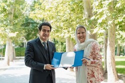 Iranian vocalist Homayun Shajarian poses with Swiss Ambassador Nadine Olivieri Lozano after accepting a letter of appreciation during Swiss National Day at the Embassy of Switzerland on August 1, 2022