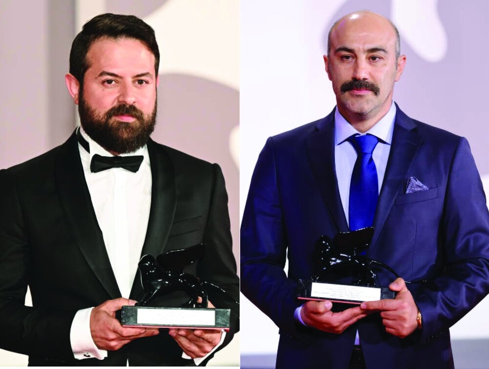 A combination photo shows director Hooman Seyyedi and actor Mohsen Tanabandeh posing with the Orizzonti awards for “World War III” during the award winners photocall at the 79th Venice International F