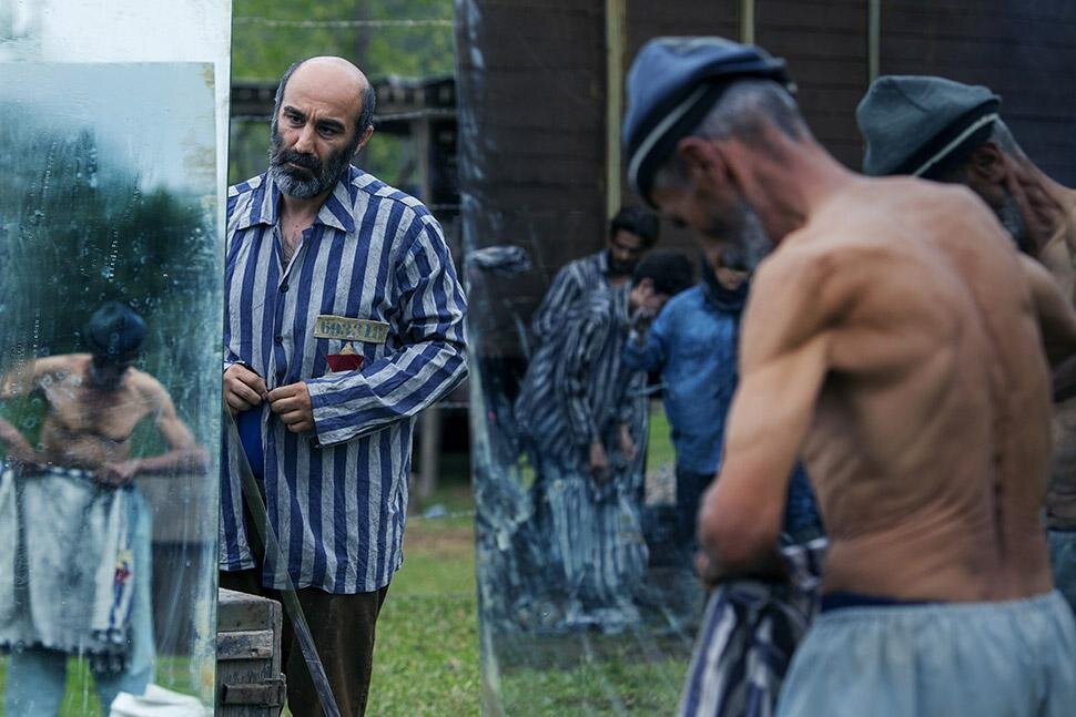 Mohsen Tanabandeh and several extras act in a scene from “World War III”.