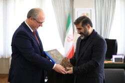 Iranian Culture Minister Mohammad-Mehdi Esmaeili (R) presents Belarussian Ambassador Dmitry Koltsov with a book on Iran during a meeting in Tehran.