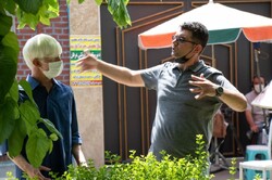 Ali Atshani (R) directs a scene from “Paper Dreams”.