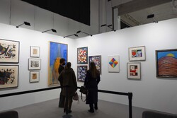 A file photo shows people visiting the WopArt – Works on Paper Fair in Lugano, Switzerland.