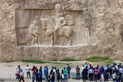 People visit Naqsh-e Rostam, a must-see travel destination embracing majestic treasures from the Achaemenid and Sassanid eras in southern Iran.