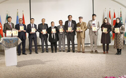 Guests hold copies of “Iqbal in the Contemporary Persian World” during the launch event of the book at the ECO Cultural Institute in Tehran on November 23, 2022. (ECOCI)