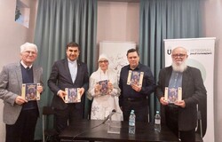 Translator Sara Esterabadeyan (C), Iranian diplomat Hossein Sadat-Meidani (2nd L), Romanian critic Dan-Silviu Boerescu (2nd R) and several others hold copies of the Romanian translation of Hafez’s poe
