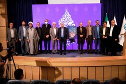 Organizers and literati pose after unveiling a poster for the 17th Fajr International Poetry Festival in Shiraz on January 7, 2023.