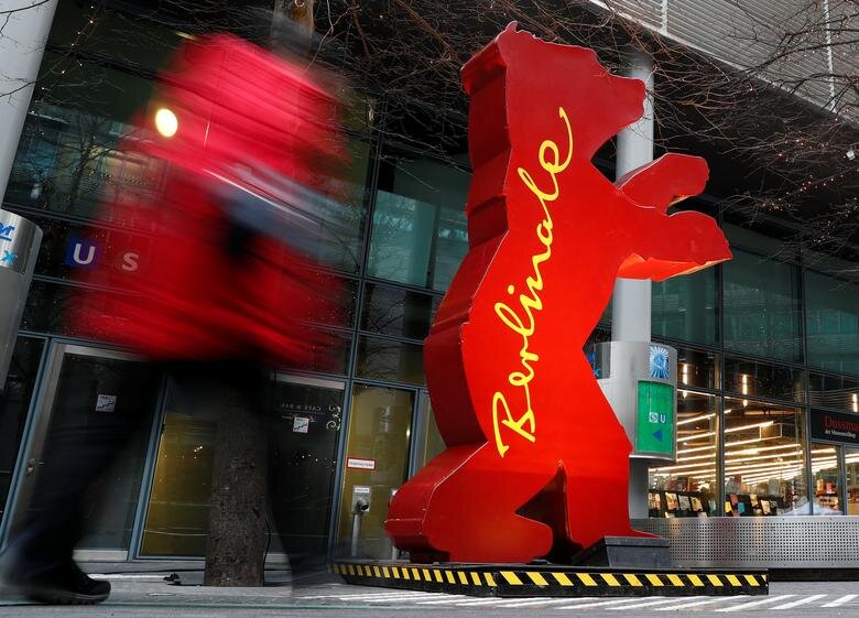 A pedestrian walks by a Berlinale bear advertisement for the 67th Berlin International Film Festival – Berlinale near the festival cinema in Berlin, Germany, February 8, 2017. (Reuters/Fabrizio Bensch