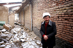 A man cries in his destroyed house after an earthquake struck the Iranian town of Khoy in West Azerbaijan Province on January 28, 2023. (IRNA/Ali Hamed-Haqdoost) 