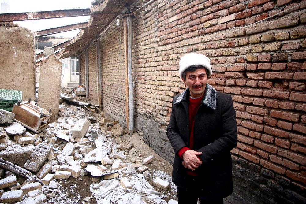 A man cries in his destroyed house after an earthquake struck the Iranian town of Khoy in West Azerbaijan Province on January 28, 2023. (IRNA/Ali Hamed-Haqdoost)