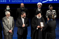 President Ebrahim Raisi honors an author during the 40th Iran’s Book of the Year Awards at Tehran’s Vahadt Hall on February 8, 2023. (ISNA/Hadi Zand)