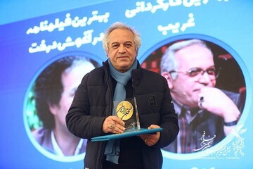 Director Mohammad-Hossein Latifi holds his prize after being honored during the National Will Manifestation Awards at Tehran’s Azadi Hotel on February 14, 2023.