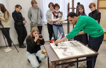 Iranian artist Hassan Ruholamin (R) holds a workshop at the Russian State University of Cinematography (VGIK) in Moscow.