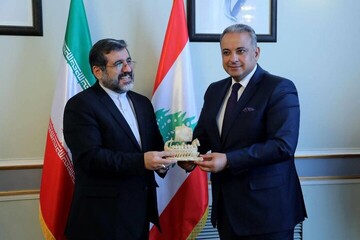 Iranian Culture Minister Mohammad-Mehdi Esmaeili (L) receives a gift from his Lebanese counterpart, Mohammad Wissam Al-Murtada, in Tehran on March 1, 2023.