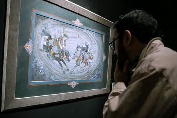 An art aficionado visits the 11th edition of Iran’s National Biennial of Persian Painting at the Saba Art and Cultural Institute in Tehran on March 4, 2023. (IRNA/Asghar Khamseh)