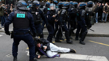French riots police apprehend a protestor