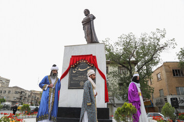 Employees of the Beautification Organization of the Tehran Municipality clad in ancient Persian costumes attend the unveiling ceremony of a sculpture of the Persian poet Sadi in Tehran on April 30, 20