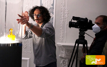 A file photo shows Hadi Afarideh (C) directing a scene in “Hollein in Iran”.