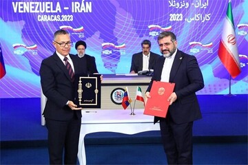 Venezuelan Culture Minster Ernesto Villegas Poljak and the Iranian Minister of Culture and Islamic Guidance, Mohammad-Mehdi Esmaeili, pose after signing a memorandum of understanding in Caracas, Venez