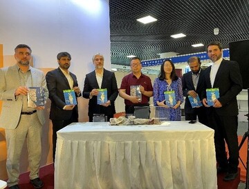Iranian officials and Chinese scholars hold copies of Chinese translations of several books by Iranian writers launched at the Iran Cultural Day at the China National Convention Center in Beijing on J