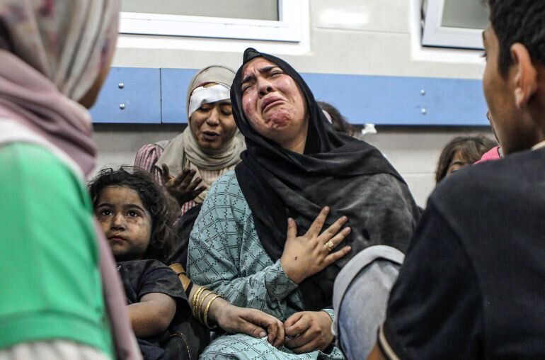 Grieving women following attack on hospital