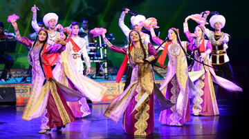 File photo depicts a Turkmen troupe staging a folk performance.