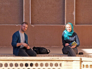A foreign couple poses for a photo during their visits to the ancient city of Kashan, central Iran.