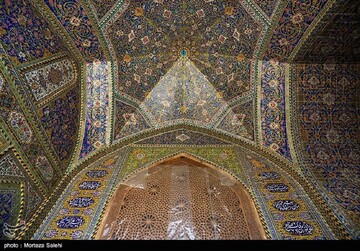 An interior view shows intricate tilework covering the dome and its load-bearing walls of the Seyyed Mosque in Isfahan.