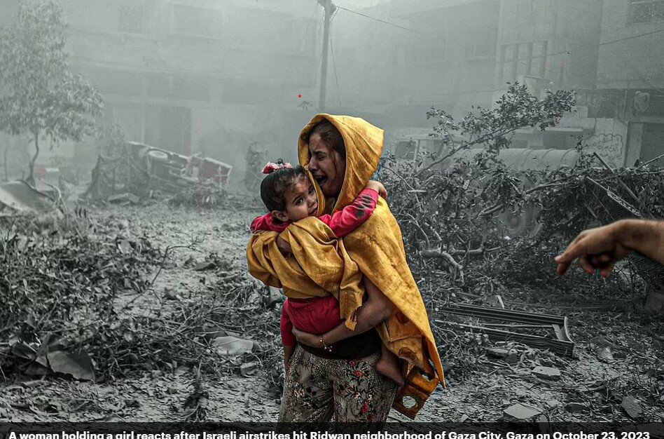 A woman holding her daughter after attack on a hospital in Gaza City