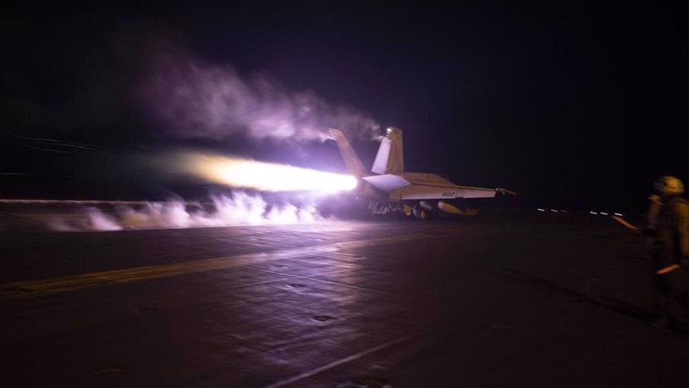 A warplane taking off from the flight deck of the USS Dwight D. Eisenhower aircraft carrier