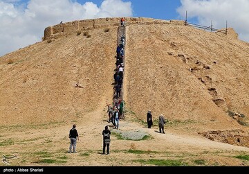 Visitors ascend stairs on Tepe Ozbaki, a millennia-old archaeological hill situated in Alborz province, near the capital Tehran.