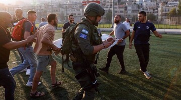 Israeli forces and medics transport casualties from a site hit by a reported rocket strike in the occupied Golan Heights