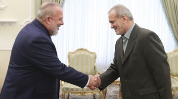 Cuban PM  Marrero Cruz and Iranian President Masoud Pezeshkian shake hands