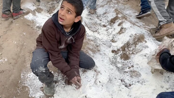 Palestinian child collecting flour