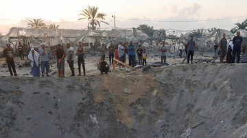 Palestinians inspect the site following the Israeli strikes on al-Mawasi, southern Gaza on 10 September 2024 (Mohammed Salem/Reuters)