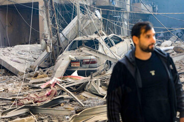 A resident stands amid the devastation following an overnight Israeli airstrike that targeted the neighbourhood of Haret Hreik in Beirut's southern suburbs on October 3, 2024. — AFP