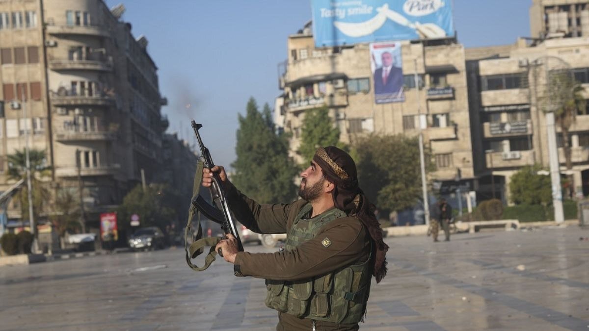 HTS militant fires in the air to create fear