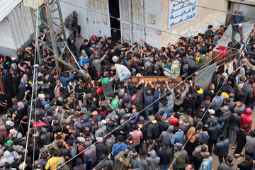 Hundreds of Palestinians gather to buy bread from a bakery in Deir el-Balah, Gaza on Saturday