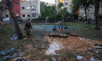 Israeli emergency services work at the scene of a missile strike on a playground, in Jaffa, south of Tel Aviv. Photograph: Reuters