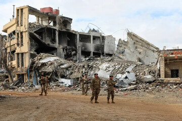 Lebanese soldiers on December 23, 2024, stand near the rubble of buildings destroyed during Israel’s attacks on southern Lebanon [File: Karamallah Daher/Reuters]