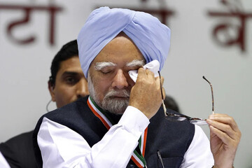 Singh wipes his eyes during an All India Congress Committee meeting in New Delhi on Jan. 17, 2014. Days earlier, Singh had announced that he would not seek a third term. Arvind Yadav/Hindustan Times v