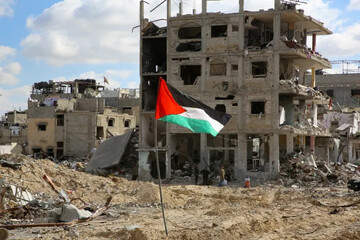 A Palestinian flag near rubble in Rafah, Gaza Strip, January 2025 Hatem Khaled / Reuters