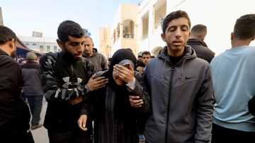 Palestinians mourn outside Gaza's al-Shifa hosptial after an Israeli attack kills hundreds on 18 March (MEE/Mohammed al-Hajjar)