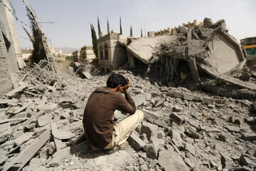 A Yemeni citizen is filled with grief over a destroyed structure