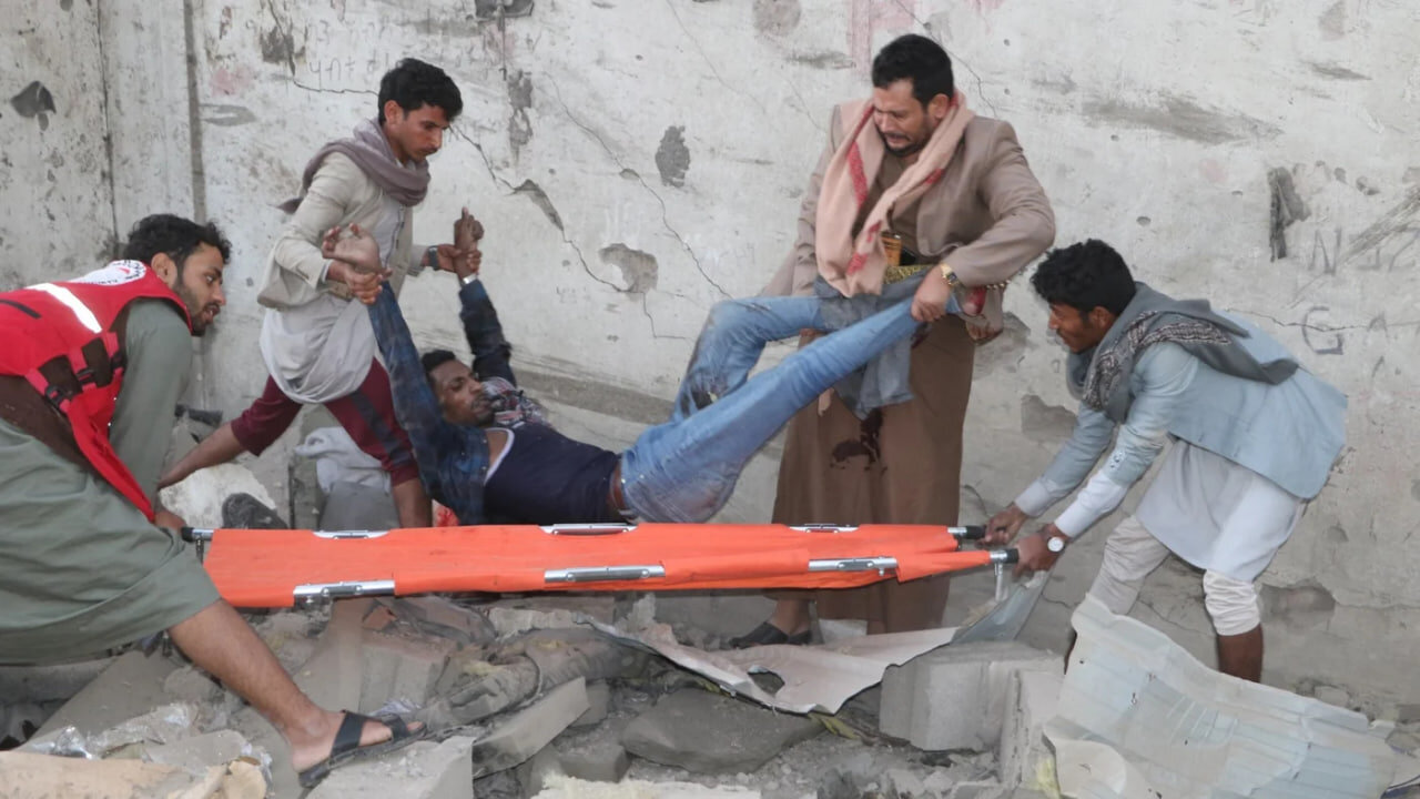 Yemeni rescuers pull an injured man from the rubble of a building hit in US strikes in the northern province of Saada on 18 April 2025 (Stringer/AFP)