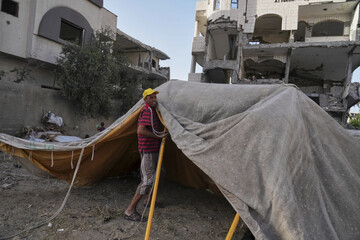 Abu Jarad sets up a new tent for his family after they were displaced by the Israeli air and ground offensive in the Gaza Strip in Gaza City, Monday, May 19, 2025. (AP Photo/Jehad Alshrafi)