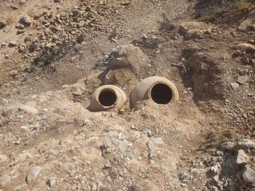 Ancient clay jars unearthed following road erosion in western Iran